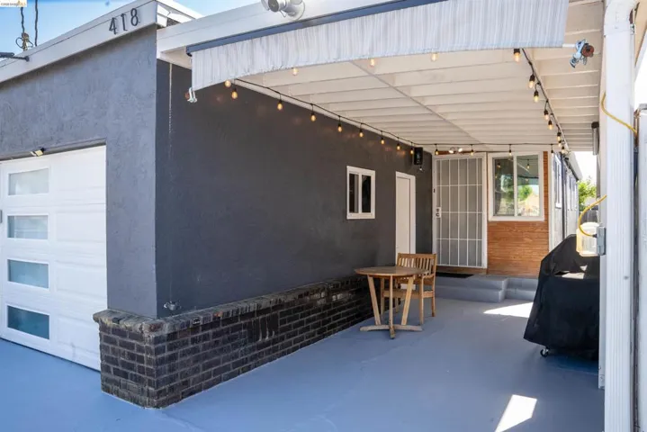 View of patio / terrace with area for grilling and a garage