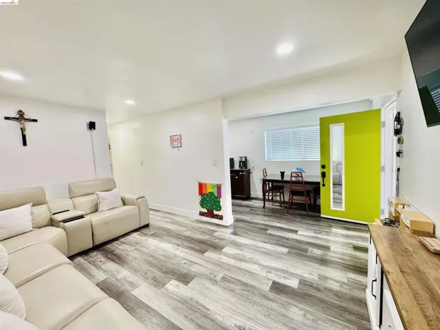 Living area featuring light wood finished floors and recessed lighting