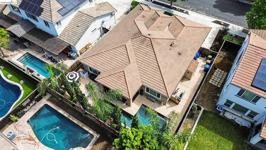 Aerial perspective of suburban area featuring a pool
