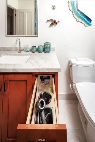 Functional cabinets with outlet to store plugged-in appliances
