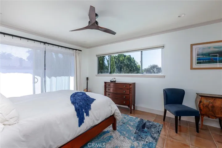 Primary bedroom w/Sliding door to balcony for daylight; or black-out drapes and shade for quiet rest.