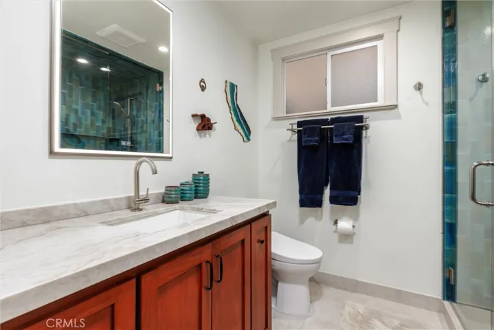 Hall bath has Custom cherry-stained cabinetry, Taj granite; lighted, defrosting mirror with interior outlet