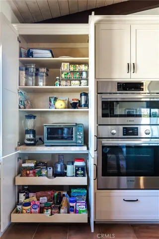 Butcher-block pull-out shelf and wired with an outlet, so appliances like blenders stay plugged in and keep countertops clear. Pull-out lower shelves.