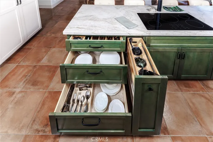 Custom island designed with deep drawers and function-specific cabinets that keep countertops clear