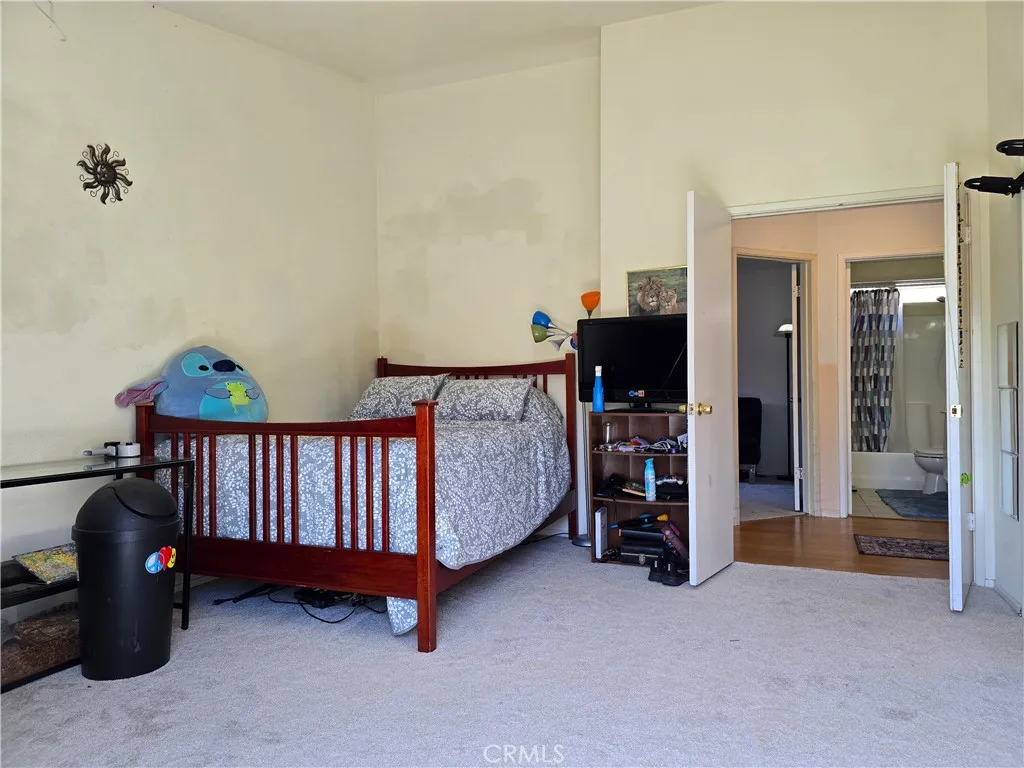 Primary bedroom offers a double door entry, vaulted ceiling, and ample space for a comfortable, flexible layout.