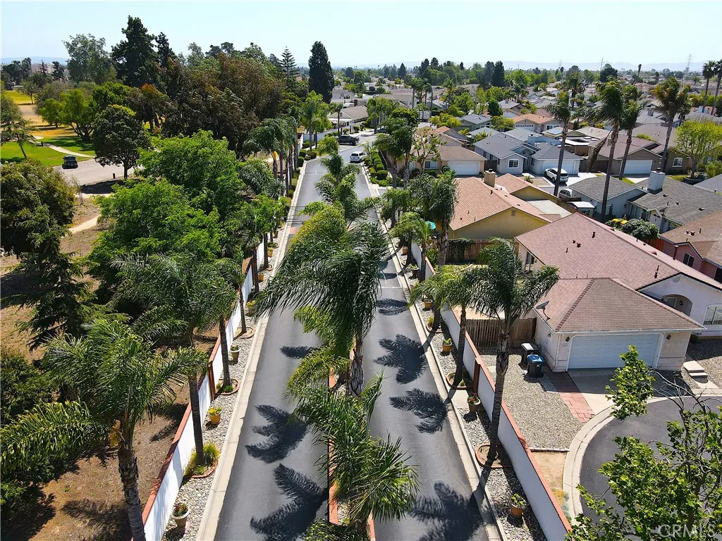 Gated entry framed by a signature palm-lined boulevard, with Preisker Park bordering the community for an inviting, well-kept arrival experience.