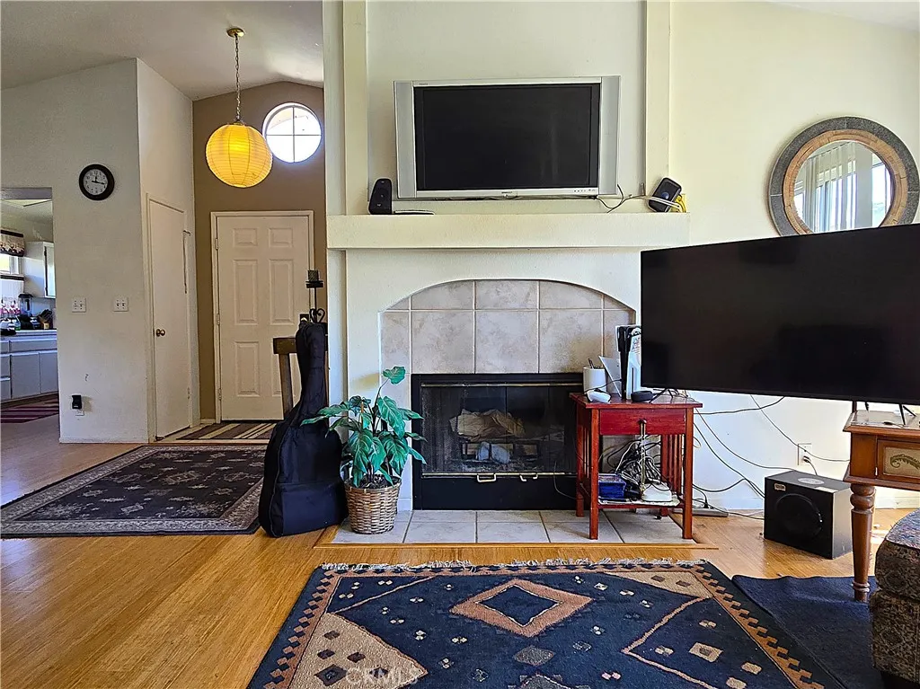 A warm, functional living area with a fireplace centerpiece, offering comfort and everyday ease within a highly sought gated community.