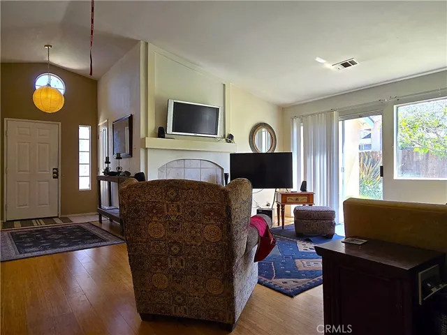 A cozy living space anchored by a fireplace and enhanced by abundant natural light—perfect for year-round comfort.
