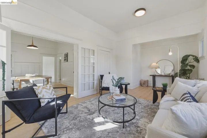 Living area with light wood-style floors and baseboards