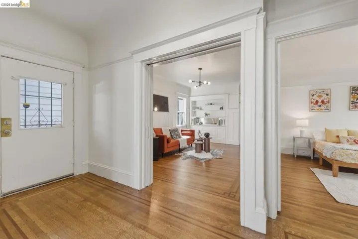 Foyer featuring light wood-style flooring and hanging lights