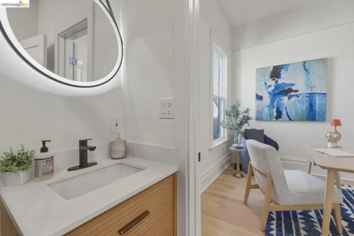 Bathroom with light wood-style flooring and vanity