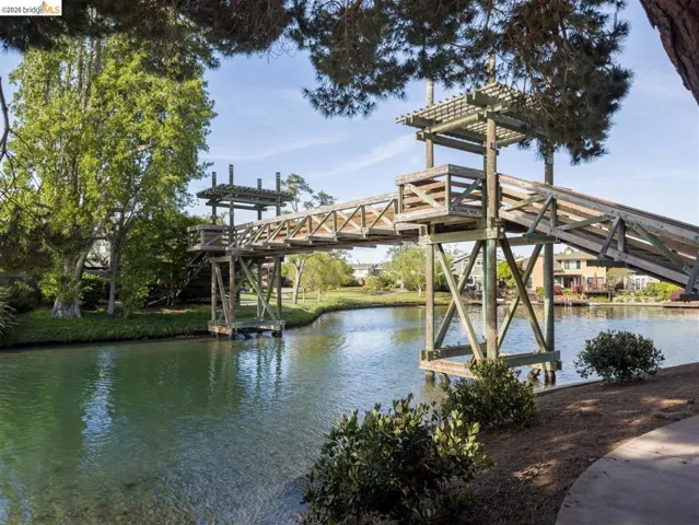 Dock featuring a water view, boat lift, and a pergola