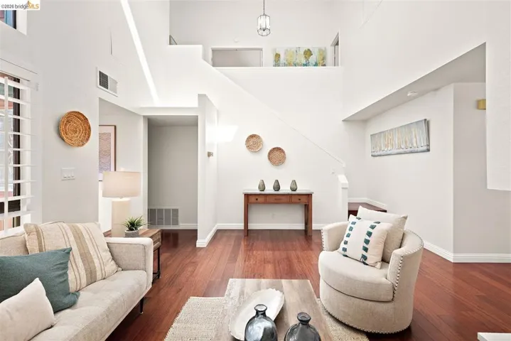 Living room featuring hardwood / wood-style floors and a high ceiling