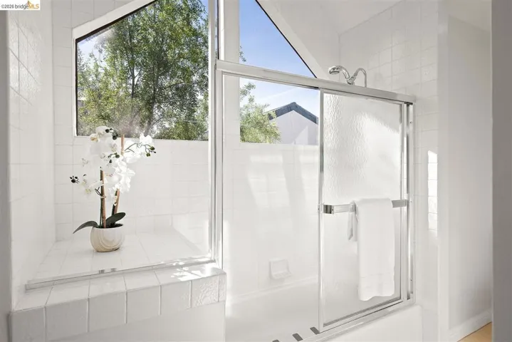 Bathroom with combined bath / shower with glass door