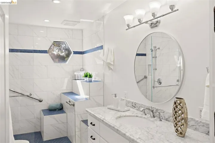 Bathroom featuring a shower stall, vanity, and recessed lighting