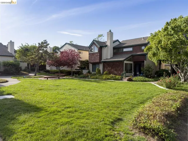 Back of property with a lawn and a chimney