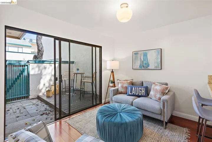 Living area with baseboards and wood finished floors