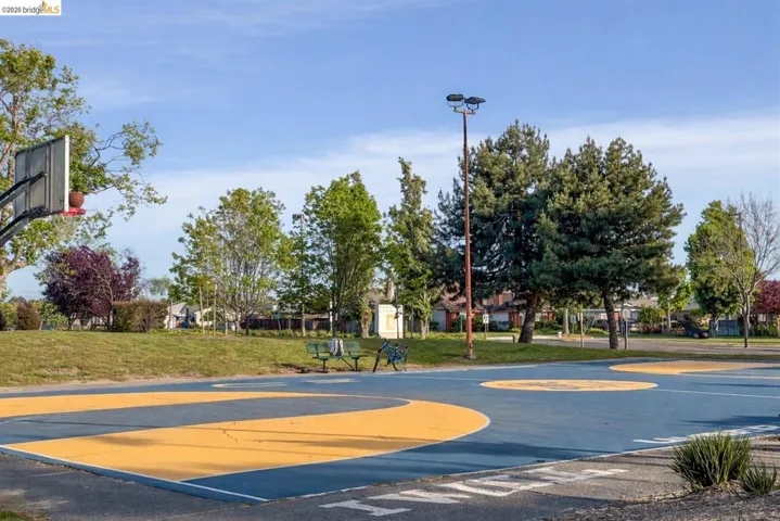 View of basketball court with a yard and community basketball court
