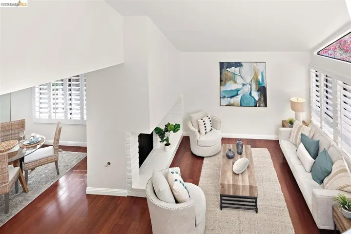 Living area featuring dark wood-type flooring and a fireplace