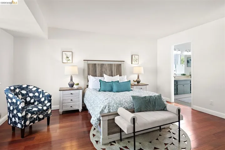 Bedroom featuring wood-type flooring and ensuite bath