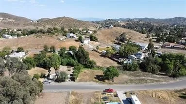 Bird's eye view drone picture of the surrounding area and neighborhood above lot.