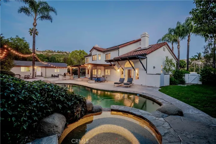 twilight view of lighted spa/pool very serene
