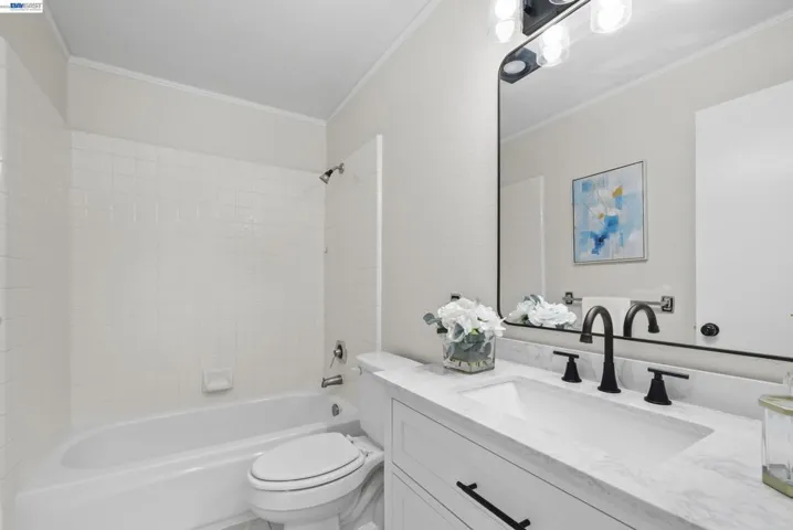 Bathroom with double sinks and storage