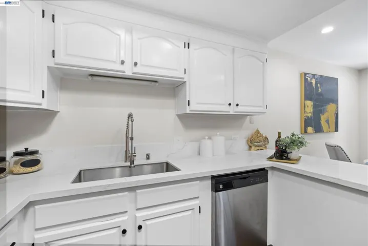 Kitchen with generous storage and clean quartz countertops and backsplash