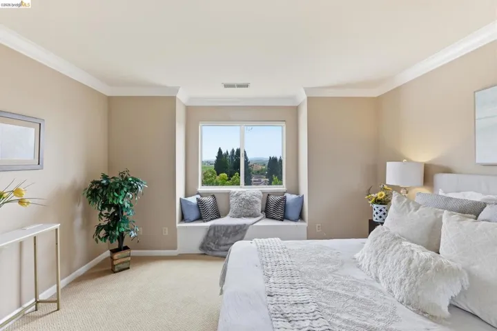 Bedroom featuring light carpet and ornamental molding