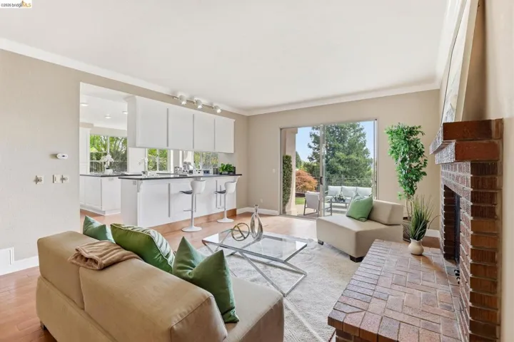 Living area with crown molding, light wood-style flooring, and a fireplace