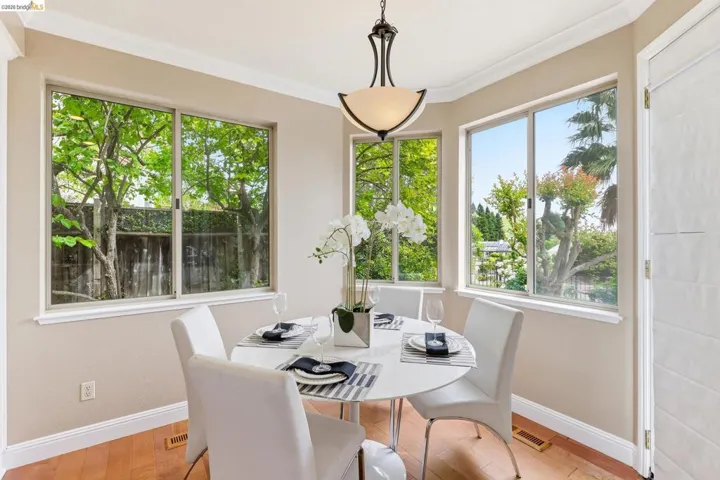 Dining space featuring light wood finished floors and crown molding