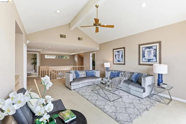 Living room with light colored carpet, a ceiling fan, and recessed lighting