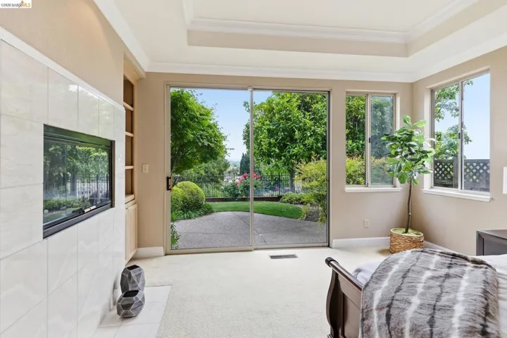 Sitting room with light colored carpet and ornamental molding