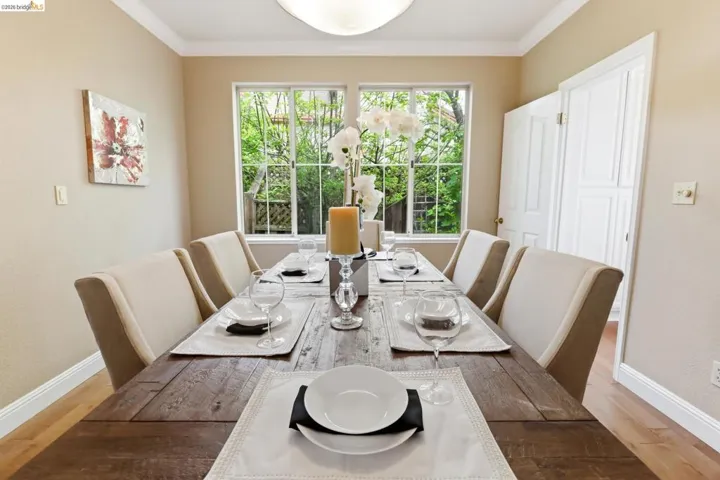 Dining area featuring light wood-style flooring and crown molding