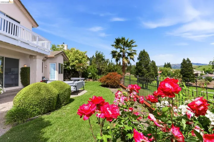 View of yard featuring a patio and a balcony
