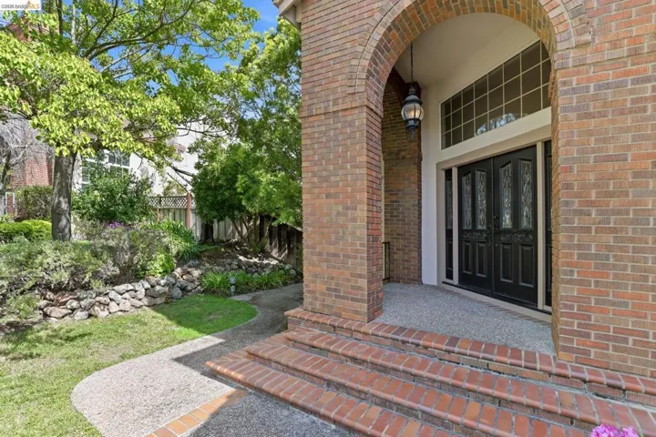 Property entrance with brick siding and french doors