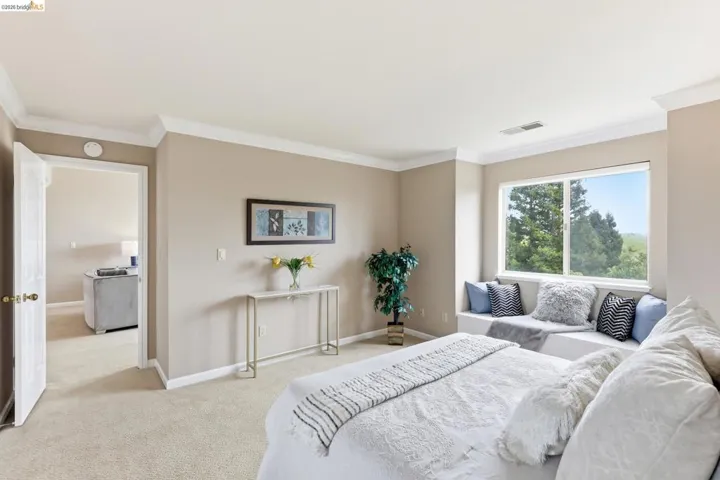Bedroom featuring ornamental molding and light carpet