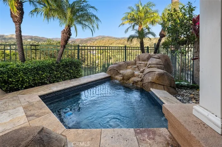 Enjoy your own hot tub with rock waterfall  in your oasis backyard!