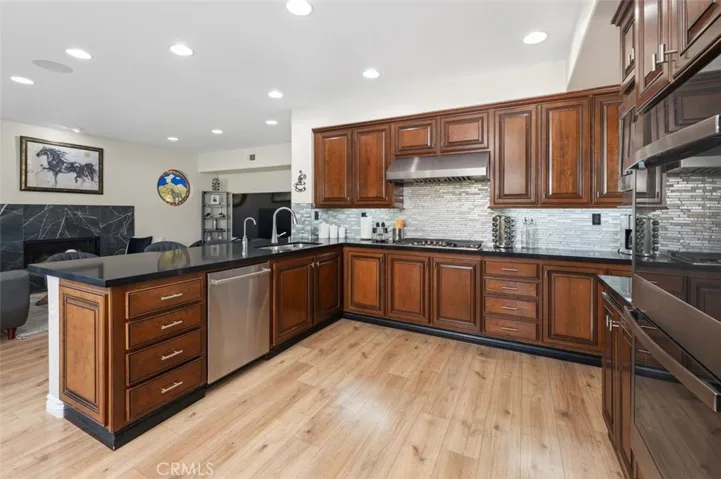 Remodeled kitchen with quartz countertops, decorative glass backsplash, new appliances & double ovens