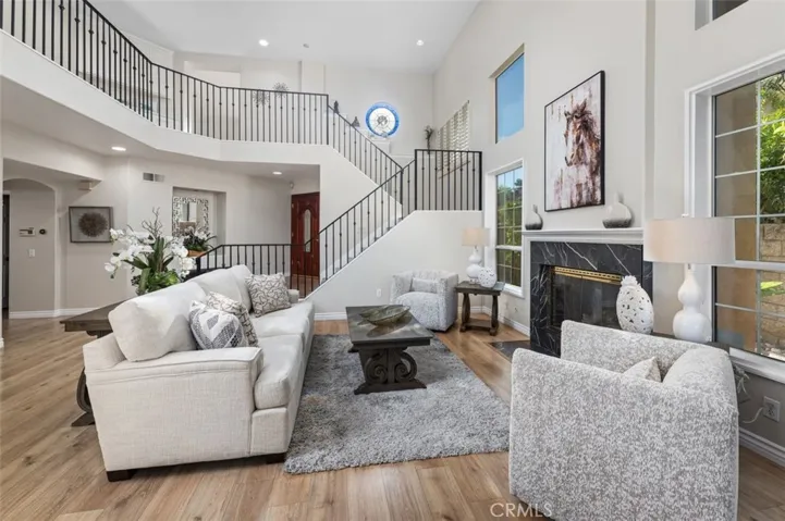 Unwind in your living room with soaring ceilings & another fireplace