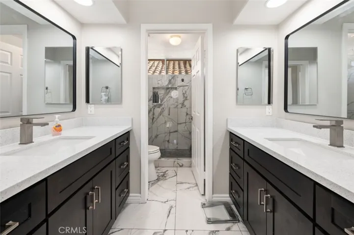 Beautiful remodeled upstairs bathroom with seperate vanities