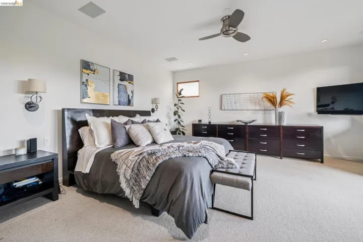 Bedroom with light carpet, a ceiling fan, and recessed lighting