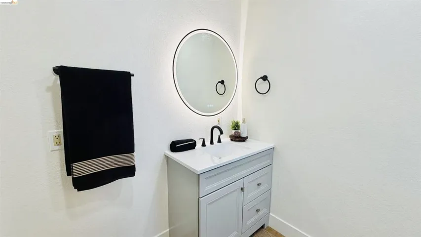 Bathroom featuring vanity and a textured wall
