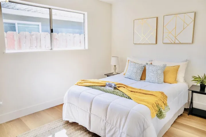 Bedroom featuring light wood-type flooring and baseboards