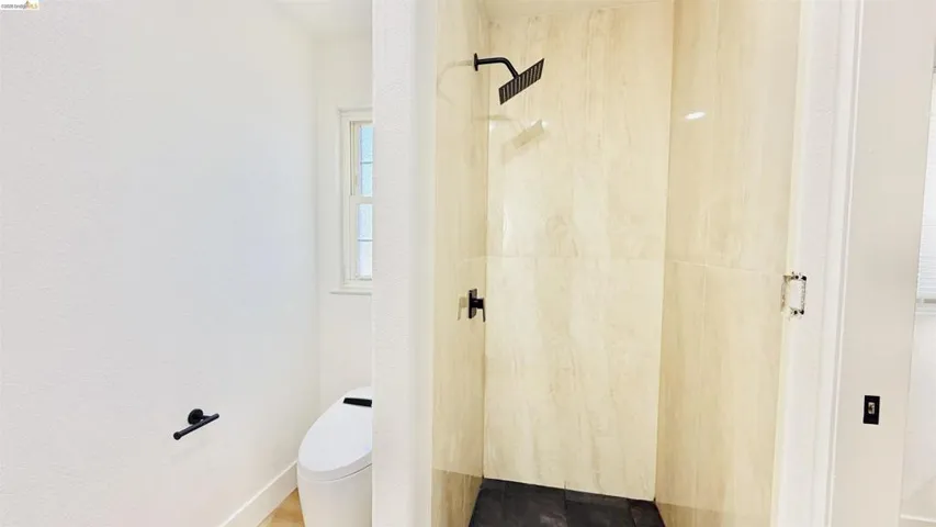 Full bathroom featuring toilet and a walk in shower