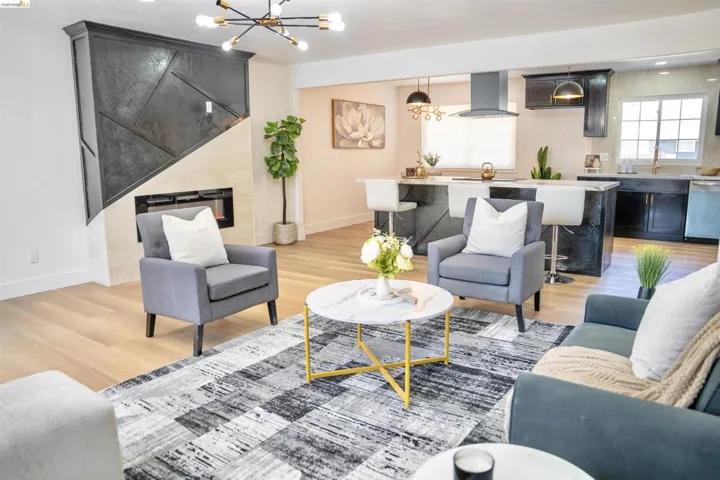 Living room with hanging lights and light wood-style floors
