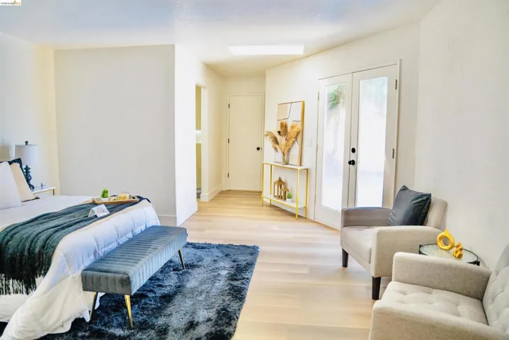 Bedroom with french doors, access to exterior, and light wood-type flooring