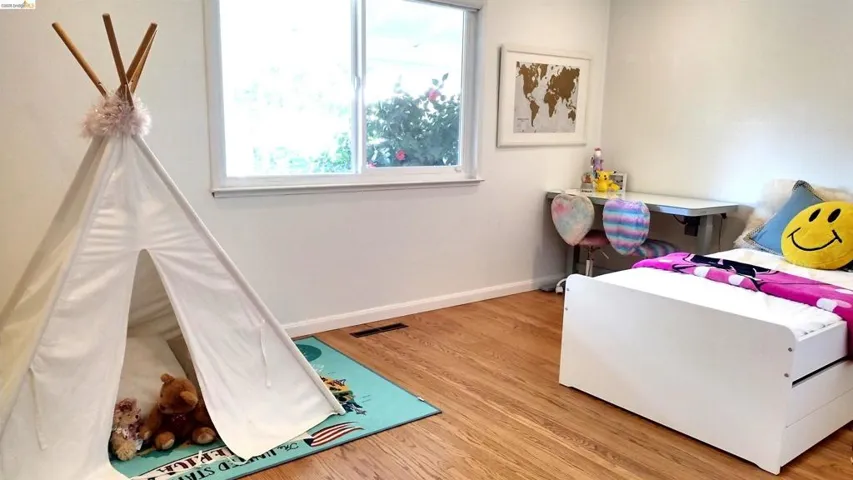 Bedroom featuring baseboards and wood finished floors