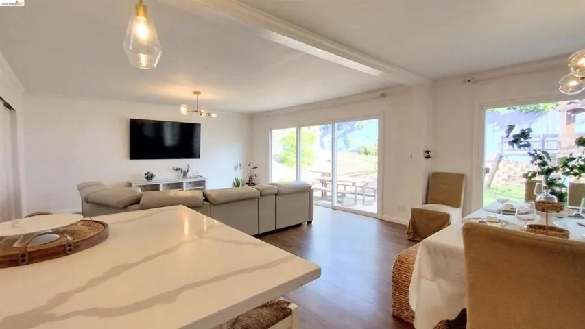 Dining room featuring hanging lights and dark wood-type flooring