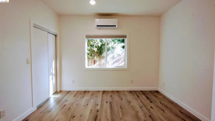 Unfurnished bedroom featuring light wood-style flooring, a closet, and recessed lighting